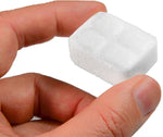 person holding white Esbit fuel tablet with fingers